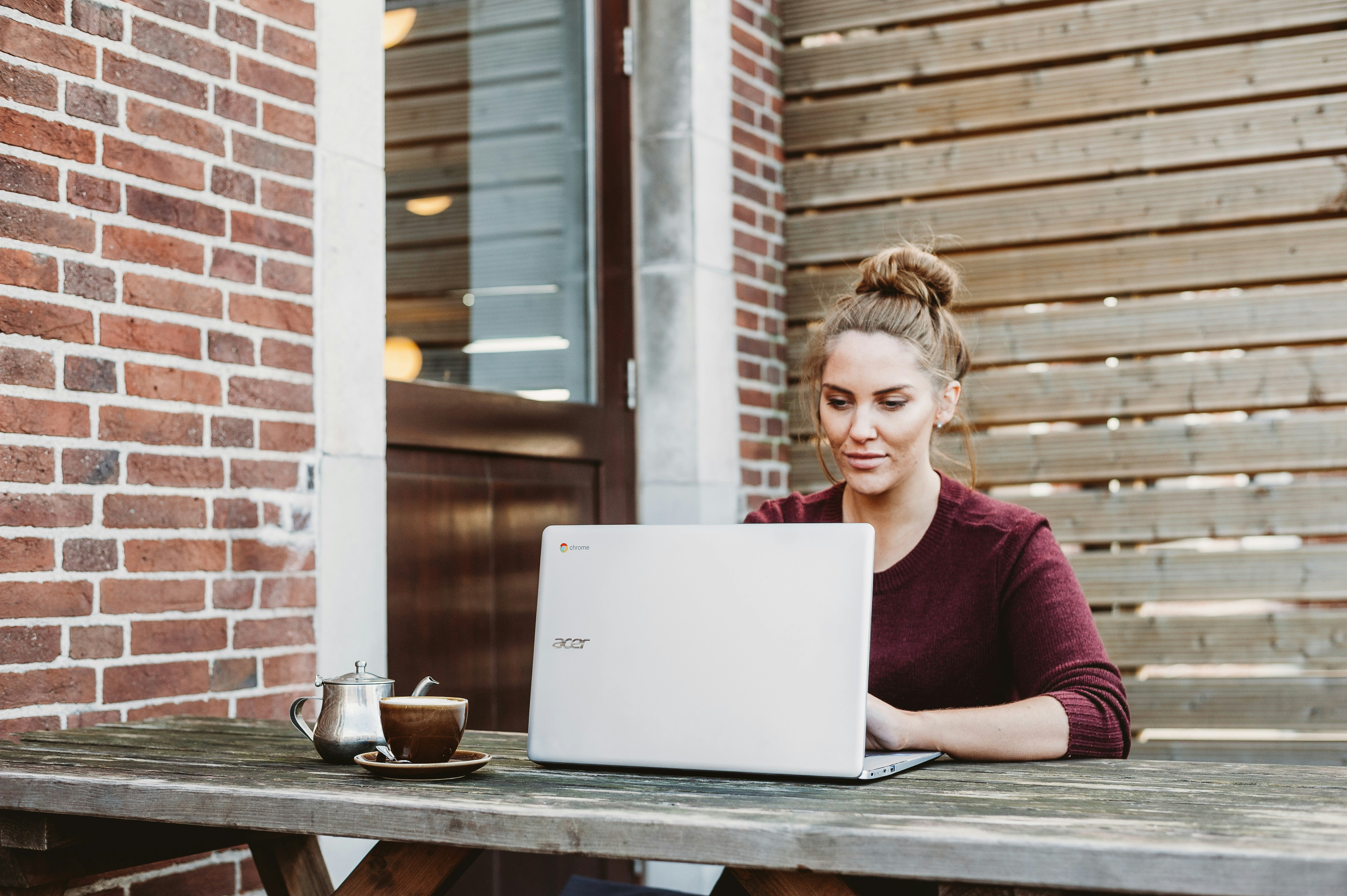 woman working on a laptop - Webflow Pros And Cons