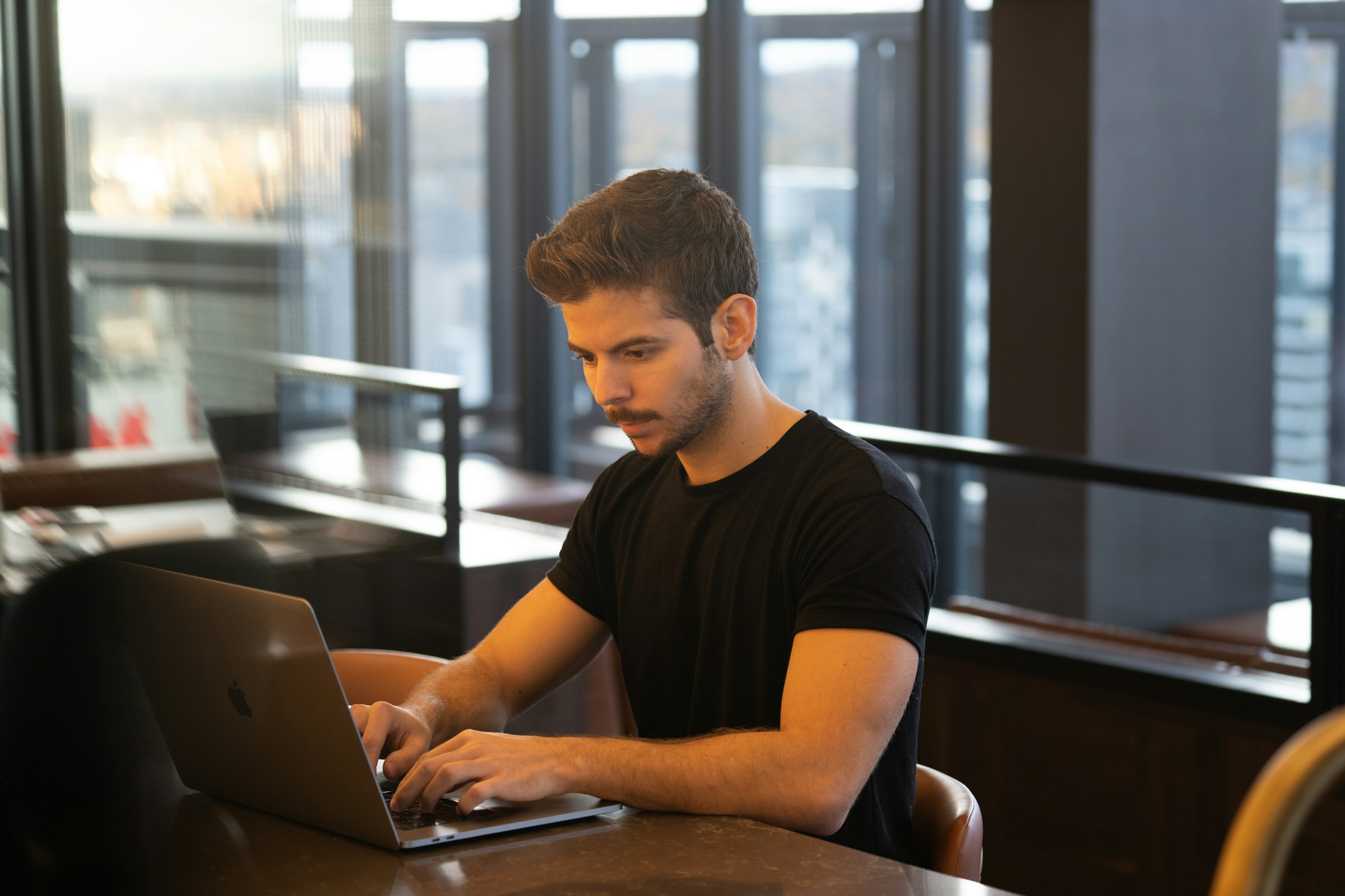 man working on a laptop - Framer Design