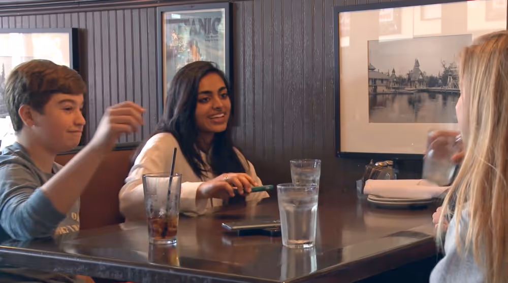 Group of teens sitting aroud a table 