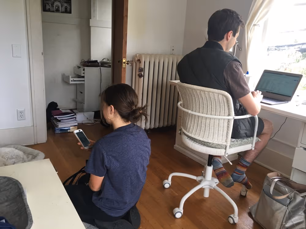 Man and woman on phone and laptop