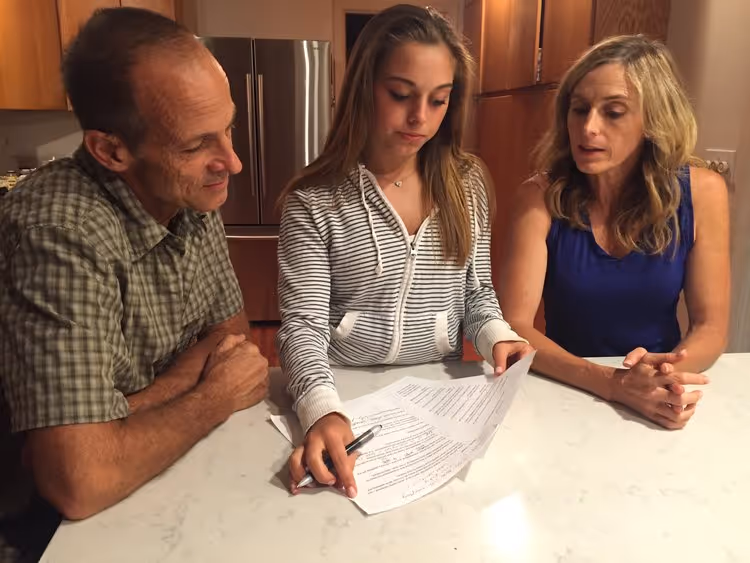 Family sitting down around kitchen island