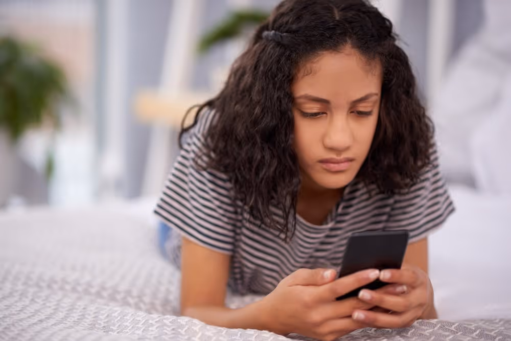 young girl scrolling through her phone