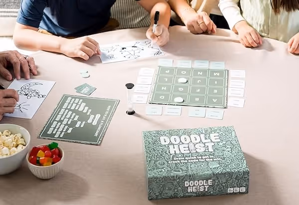 a table with the green box for doodle heist on it.