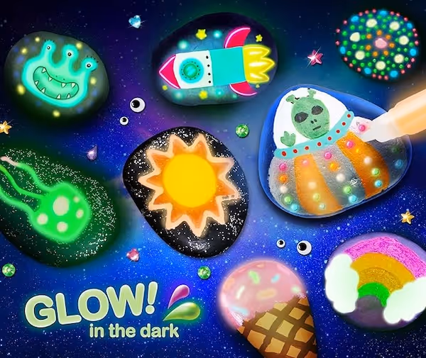 various painted rocks with different designs like the sun, an alien and a rocket ship.