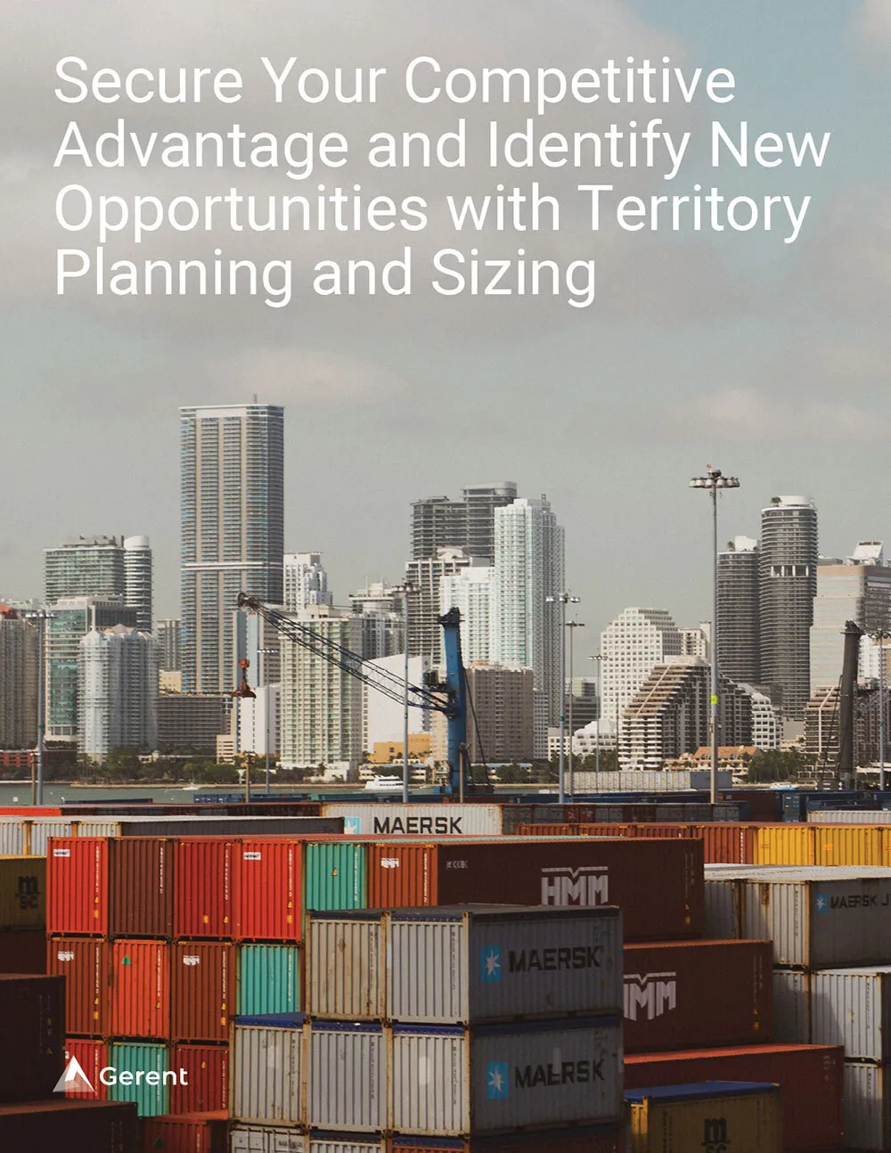 shipping containers stacked at a waterfront port with city buildings in the background