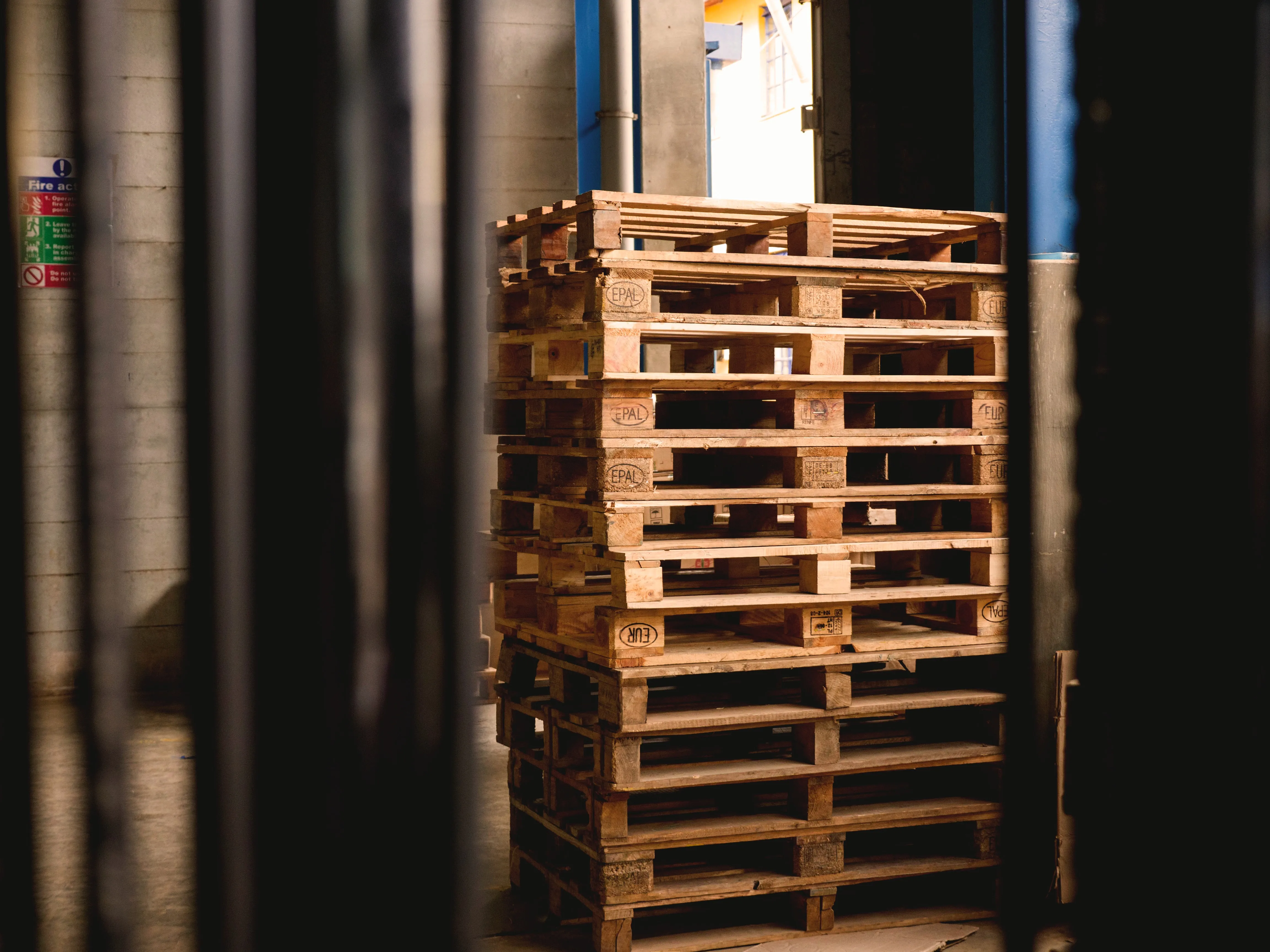 Empty shipping pallets stacked on a warehouse loading dock