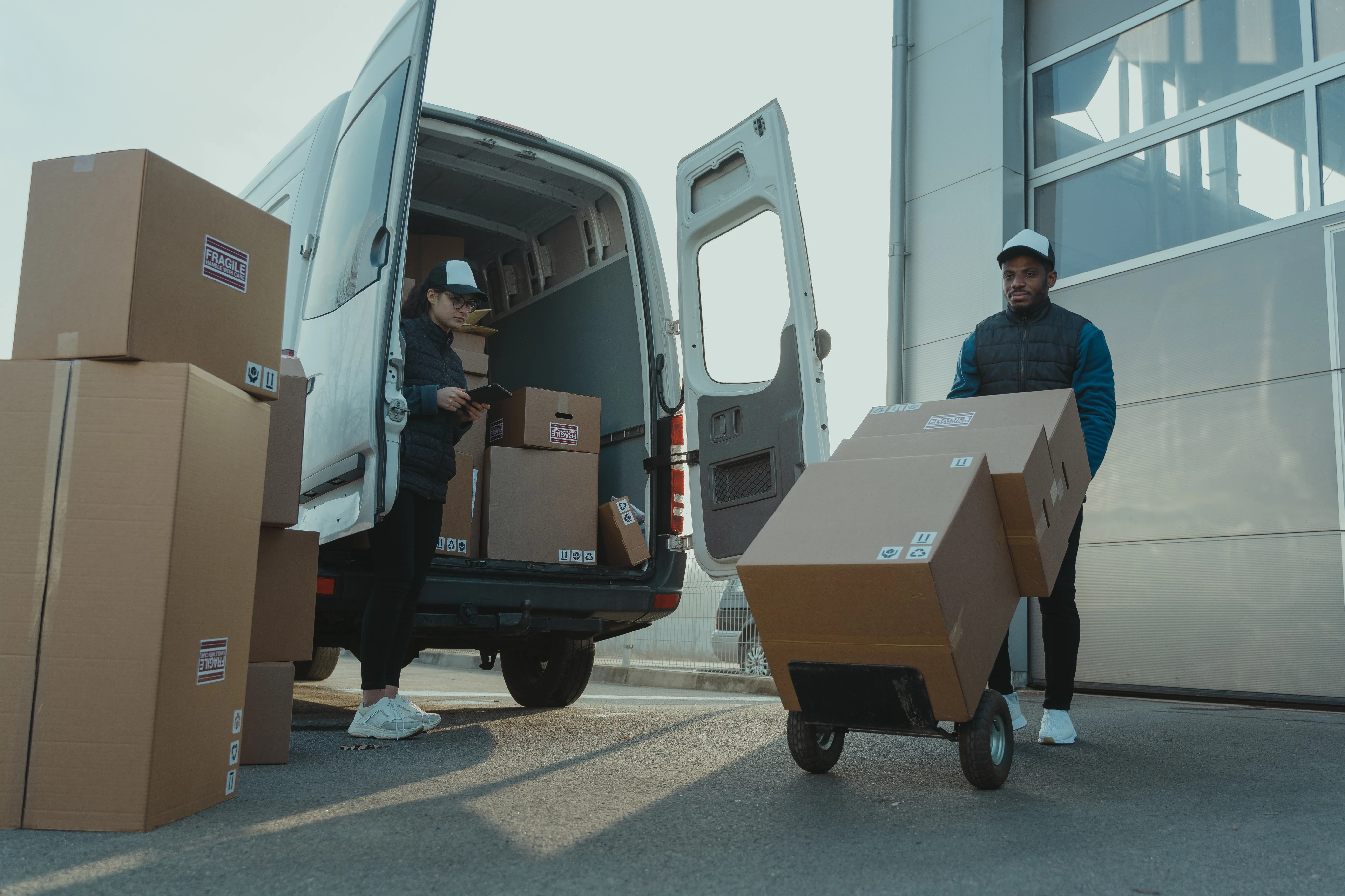 Two workers unloading a delivery van