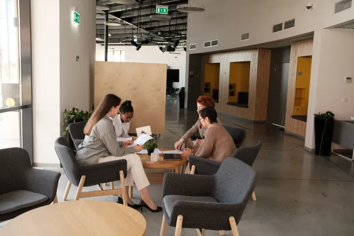 Group of young workers discussing at a desk.