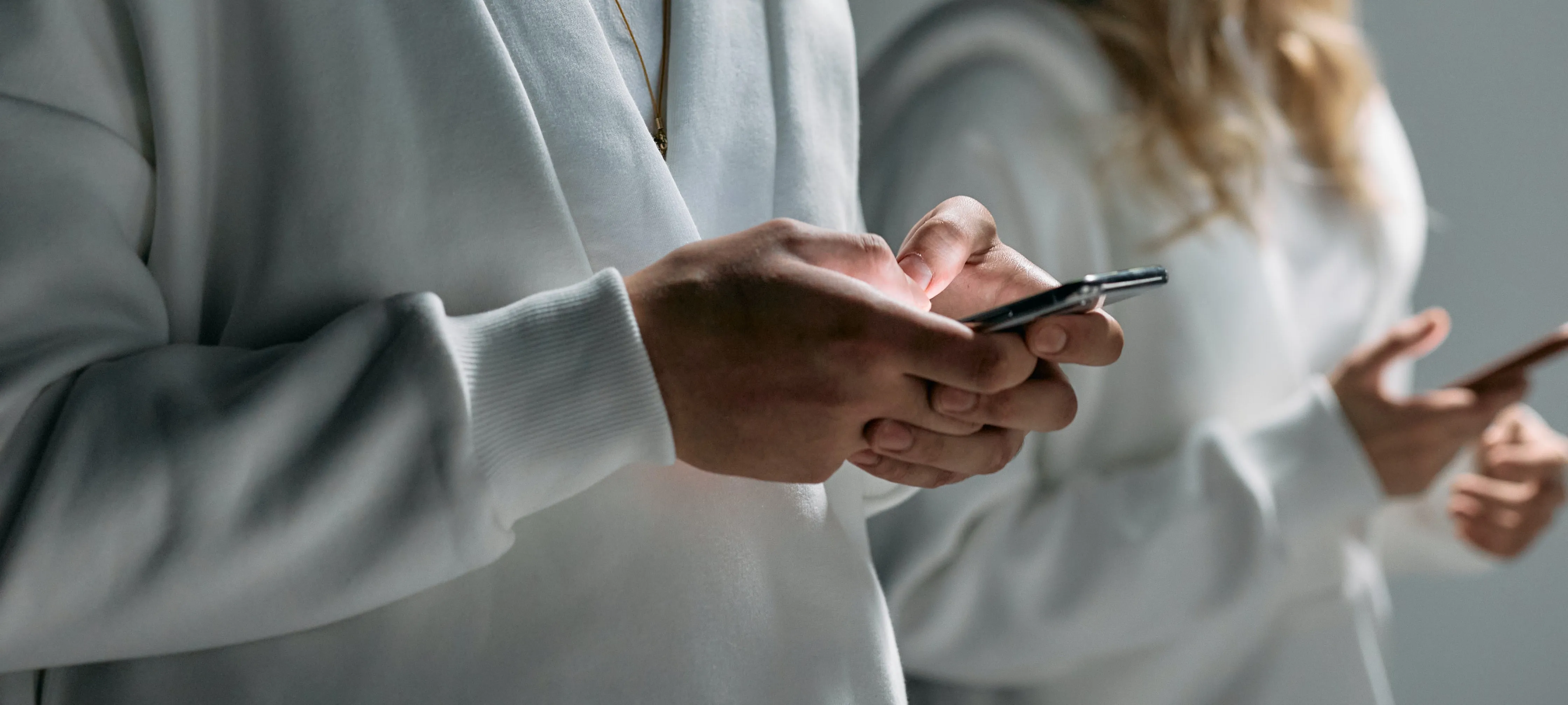 Two people on their phones browsing the web