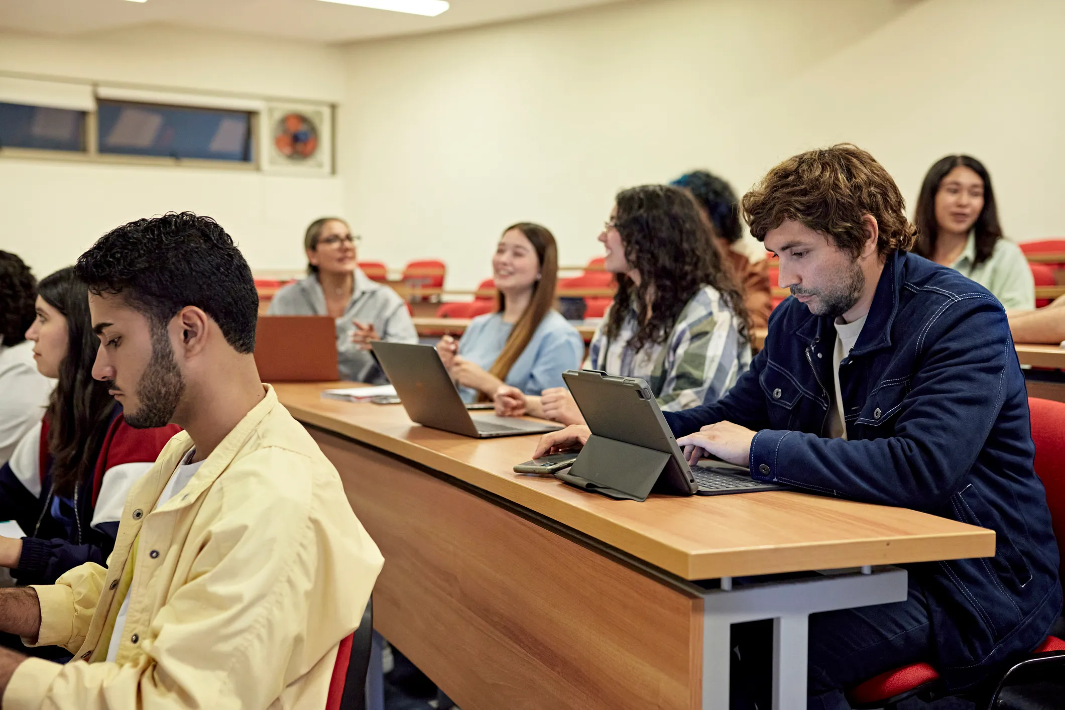 Lecture hall with students looking at computers
