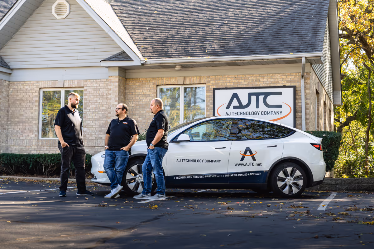 Small team working together in a bright Hampshire coworking space with laptops and whiteboards
