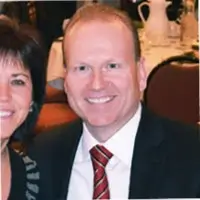 Smiling couple at a professional business event representing AJTC managed IT services team in Homer Glen IL