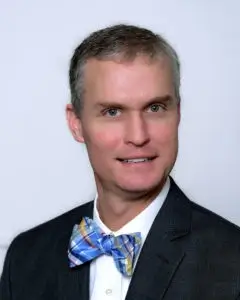 Smiling IT professional in bow tie, representing AJTC managed services team in Homer Glen IL