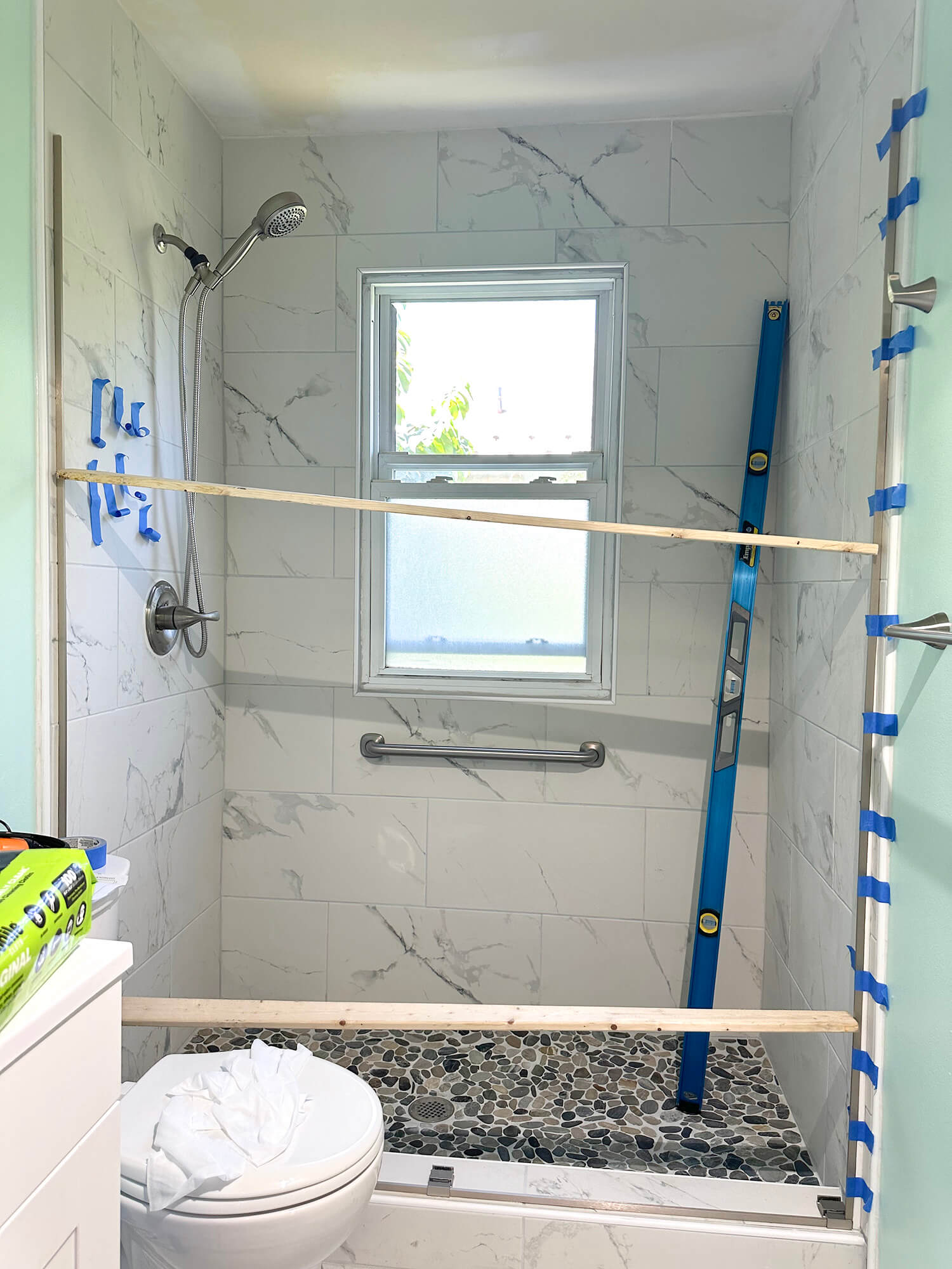 Bathroom shower getting ready for sliding door being placed