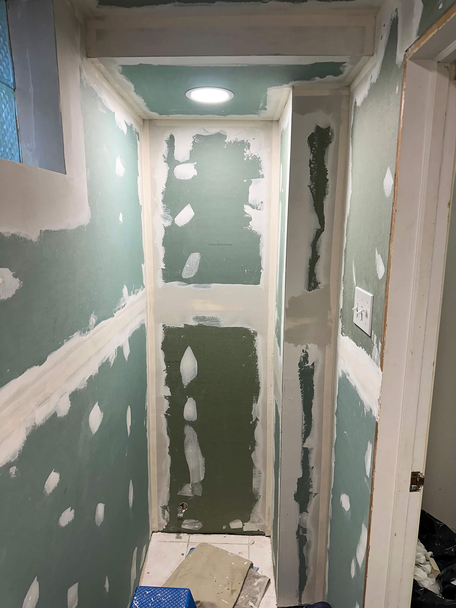Toilet section with new drywall plastered