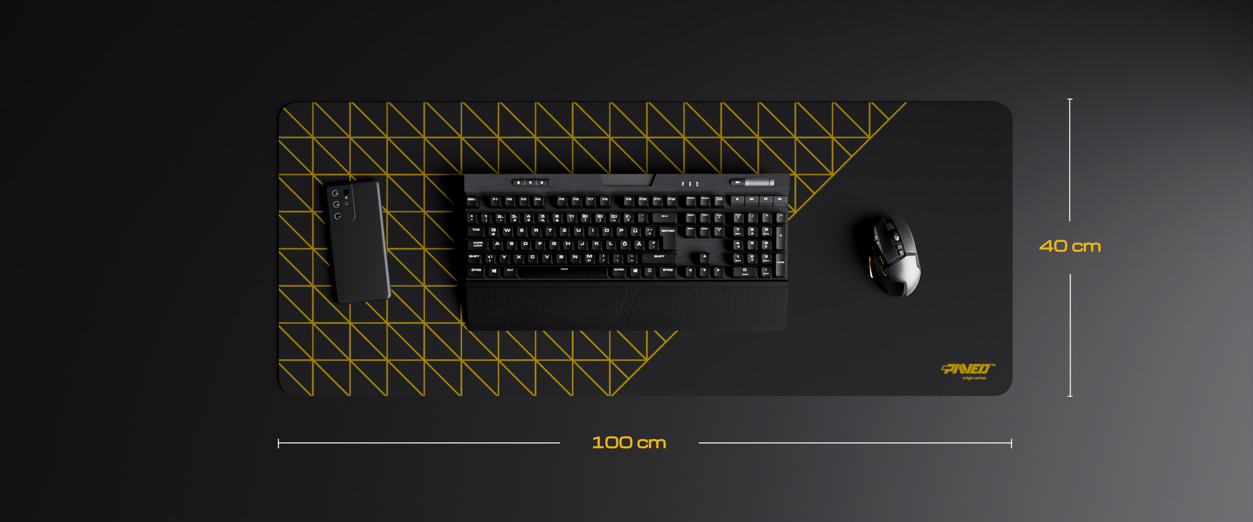 Black desk mat with yellow geometric lines, measuring 100 cm by 40 cm, holding a keyboard, mouse, and smartphone. PAVED™ Night Desert Grid Runner, right handed variant.