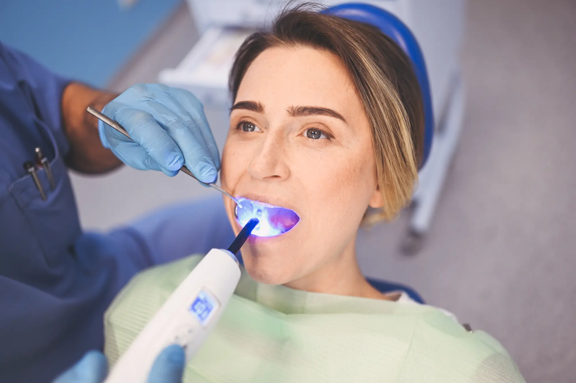 man sitting in dental exam chair and smiling