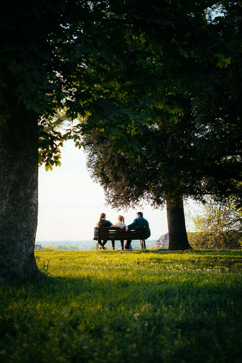 Peaceful moment shared on a park bench, reflecting how proper insurance planning protects life’s most important relationships.”