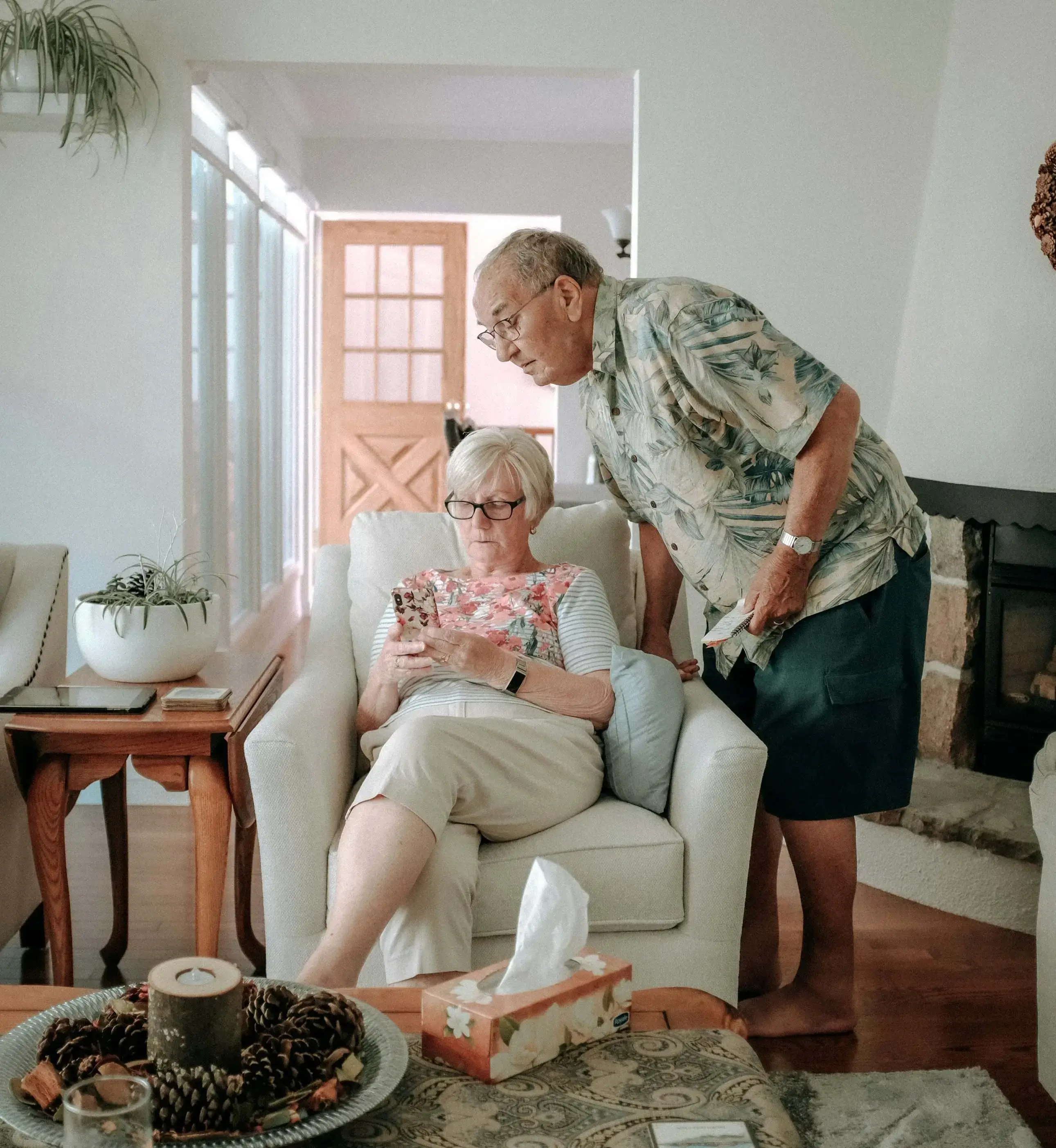 Senior couple using smartphone at home – retirement planning and financial guidance Canada