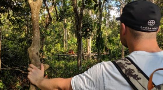 Man with Endeavour Wealth cap looking into forest – values-driven financial planning