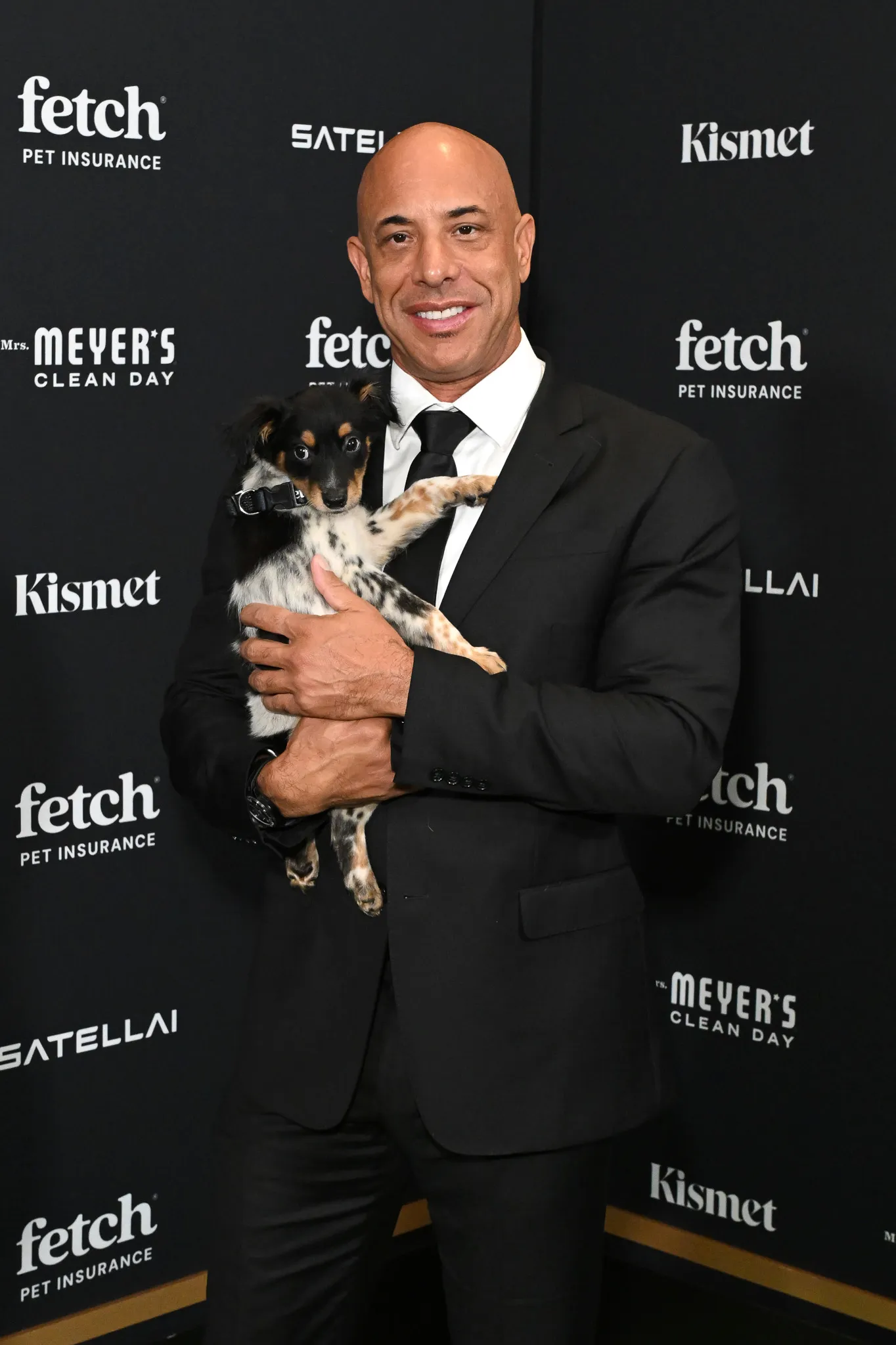 Kwane Stewart poses with Rescue Pup from North Shore Animal League America.