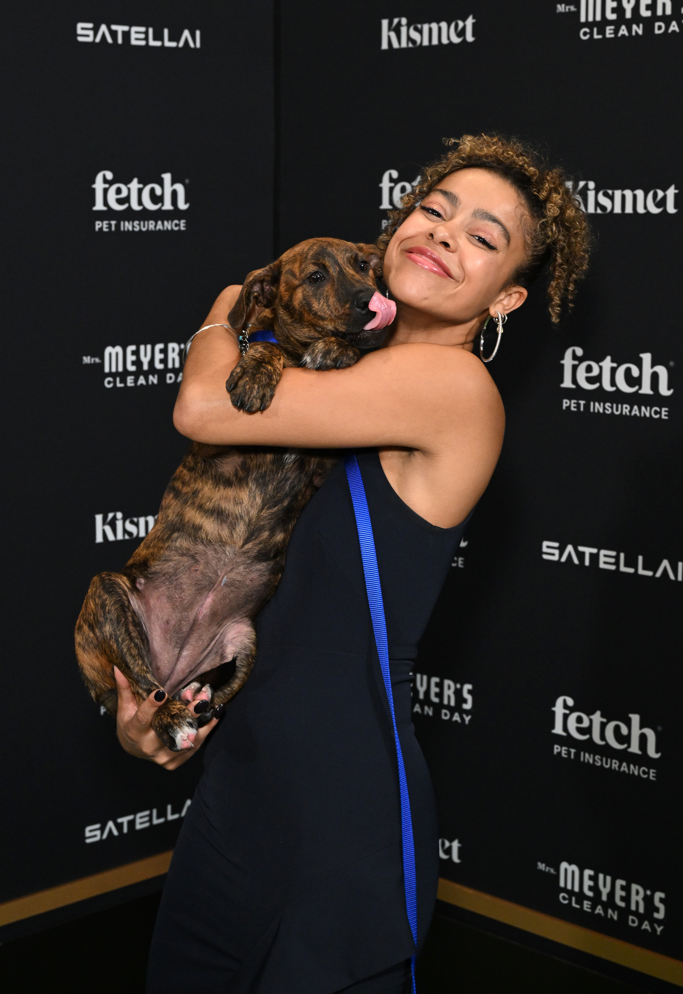 A guest poses with Rescue Pup from North Shore Animal League America.