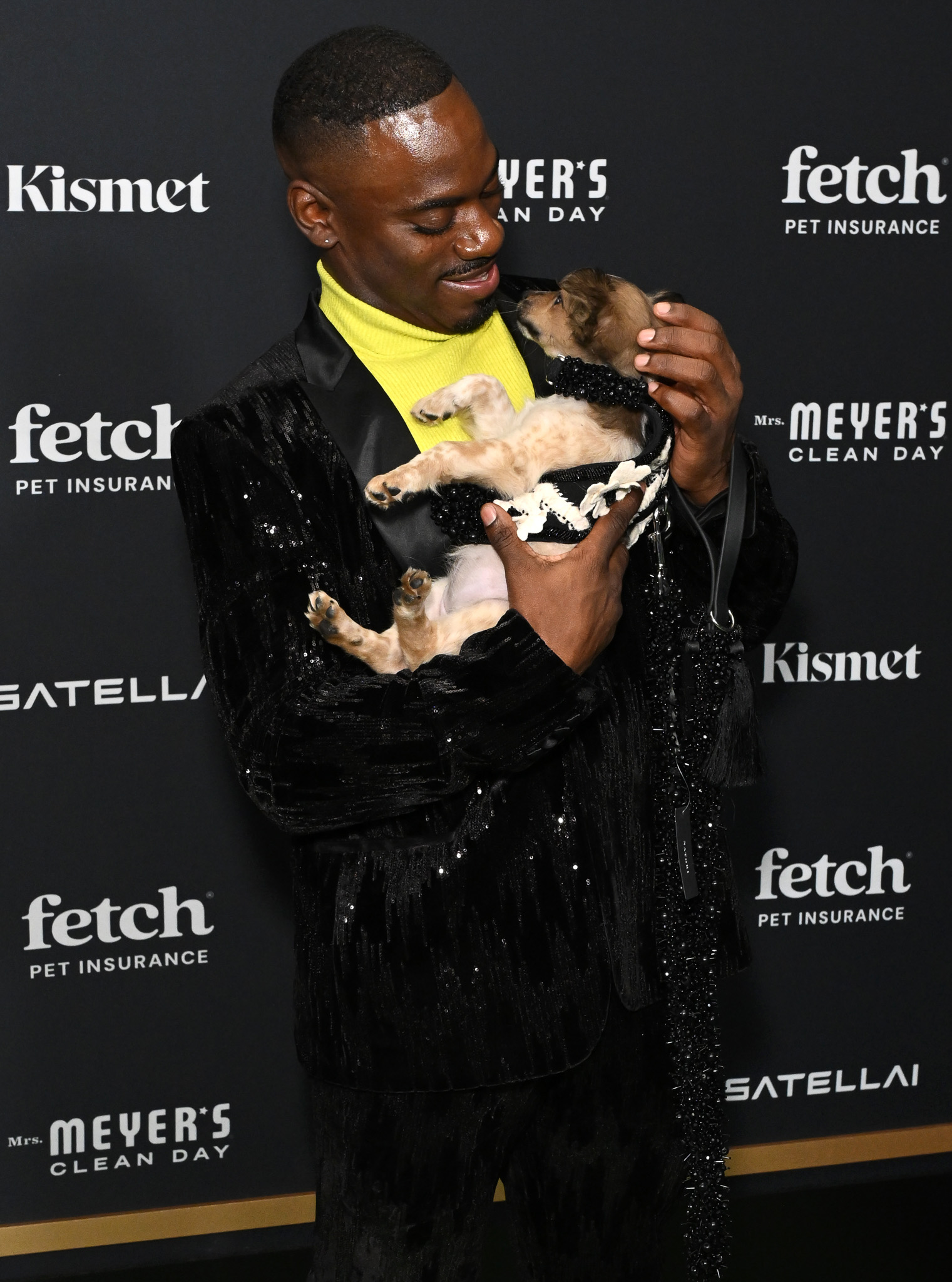 A guest poses with Rescue Pup from North Shore Animal League America at the 2025 Fetch Pet Gala.