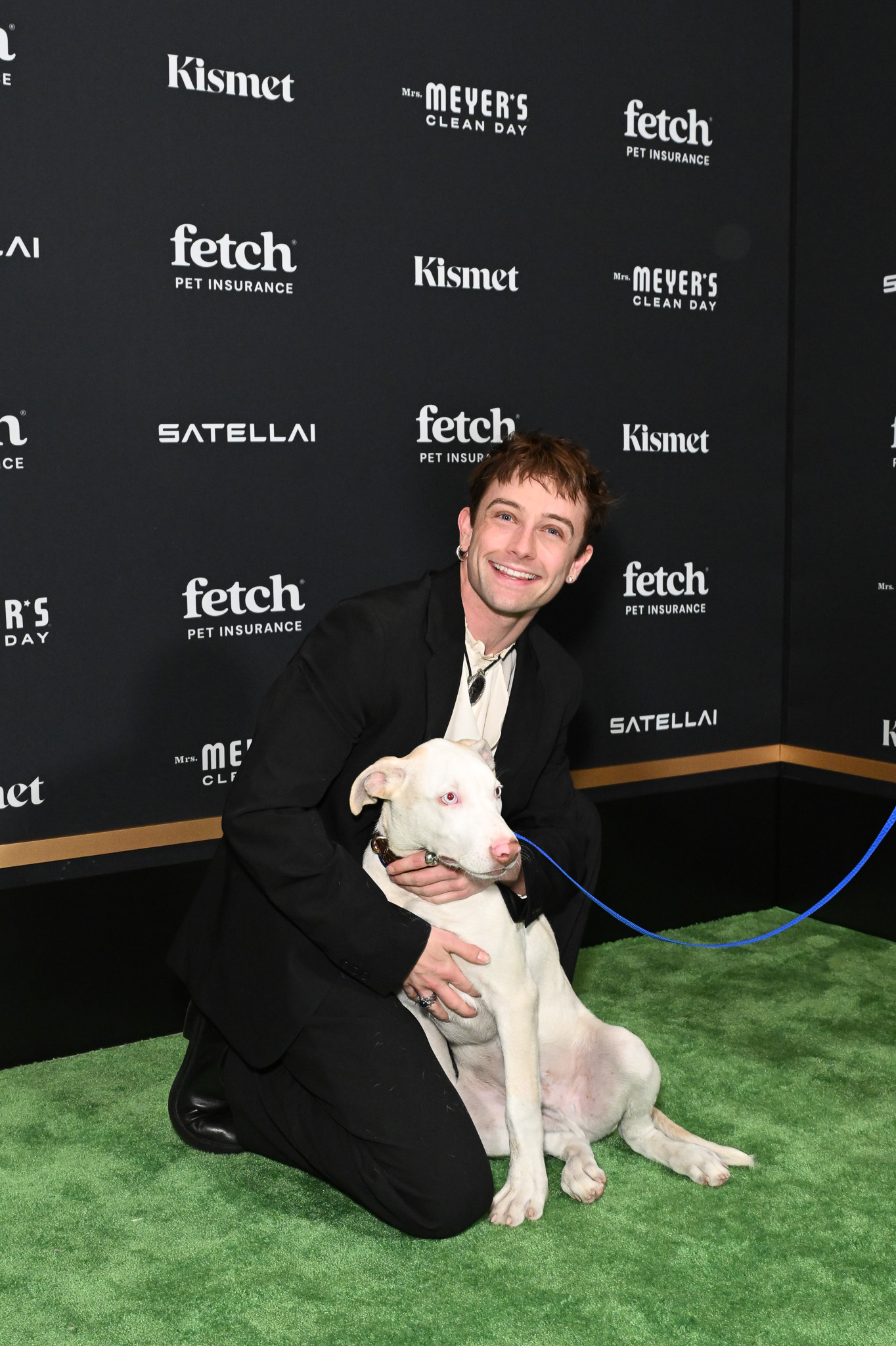 Guest poses with rescue pup from North Shore Animal League at the 2025 Fetch Pet Gala.