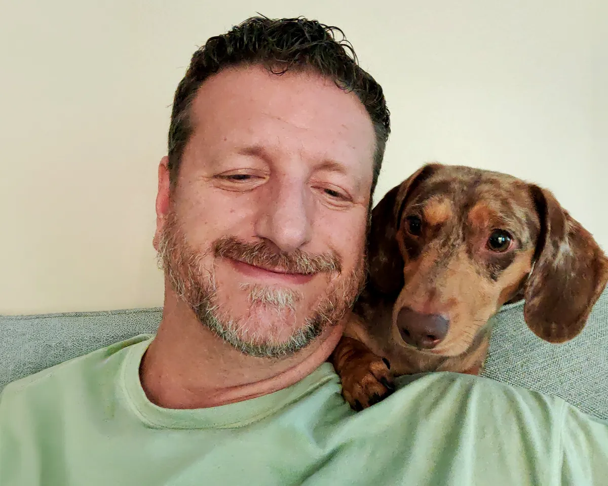 Fetch Pet Insurance Member Chad with his brown dog, Charlie