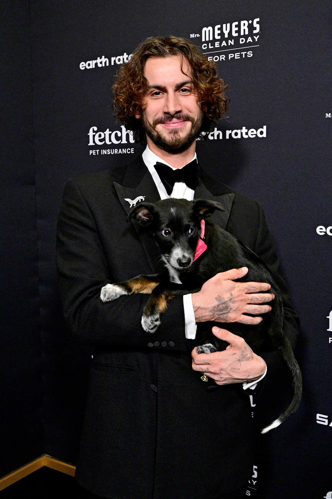 Christian Cowan on the green carpet with a pup from North Shore Animal League wearing a SATELLAI Go Collar at the 2026 Fetch Pet Gala.