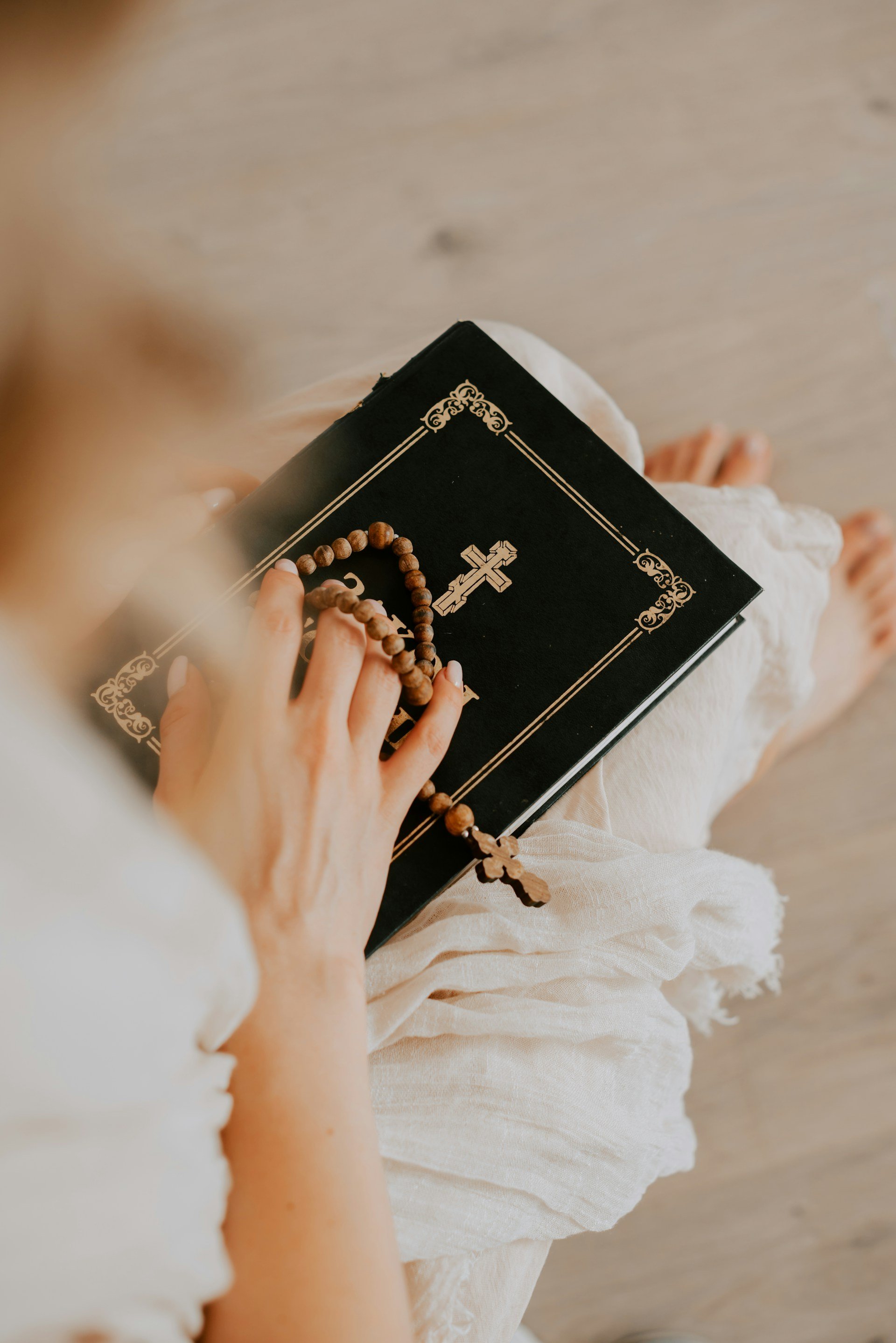 Wooden rosary resting on a prayer book