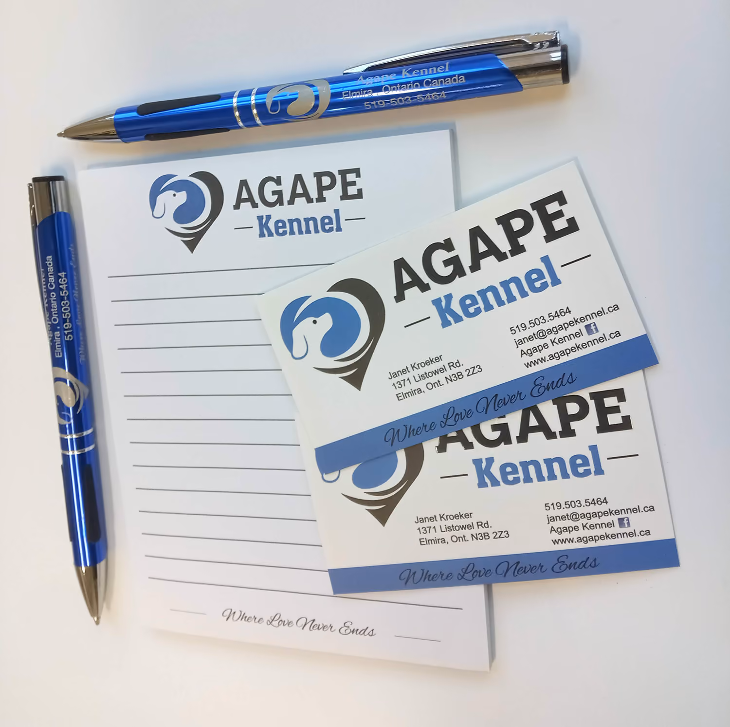 Notepad and pens are branded with "AGAPE Kennel" logo. 