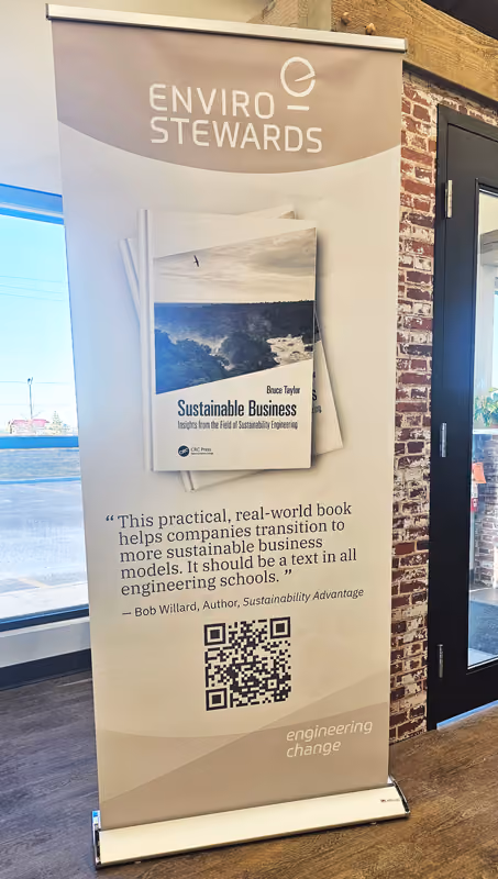 Photo of a roll-up banner with Enviro-Stewards branding and information