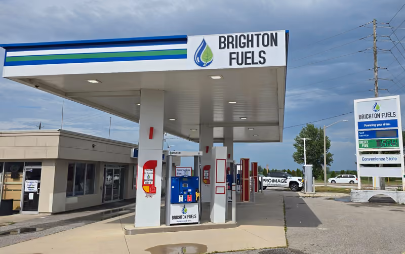 Photo of the gas station with Brighton Fuels branding; wall signs and pylon signs