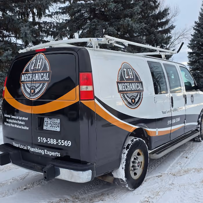 Photo of a van with partial wrap of Z.H Mechanical showing branding and contact details