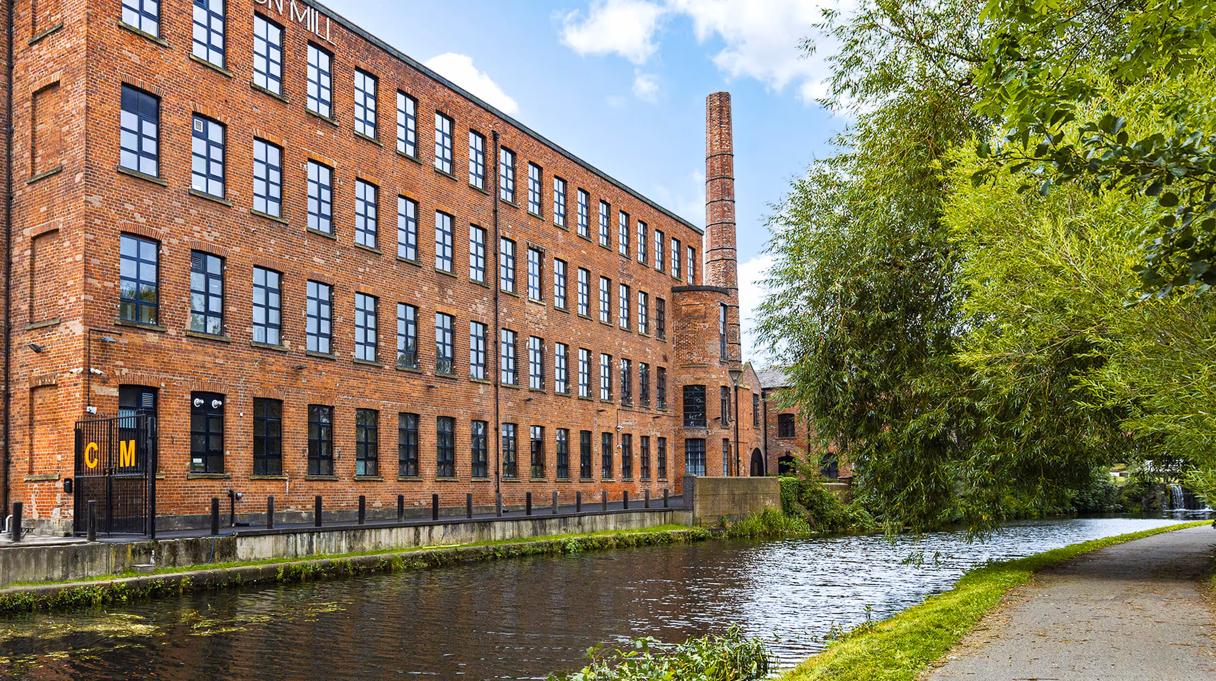 Canal side view of Castleton Mill on the Leeds Liverpool canal, offering offices to rent in Leeds