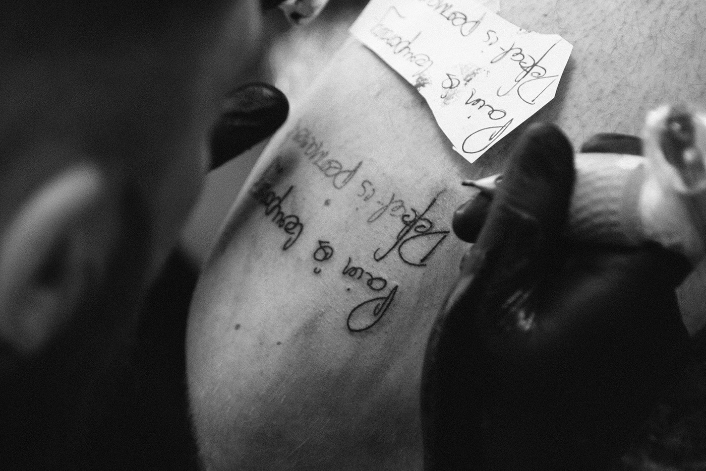 Photo of Richard, getting a tattoo of cycling quote