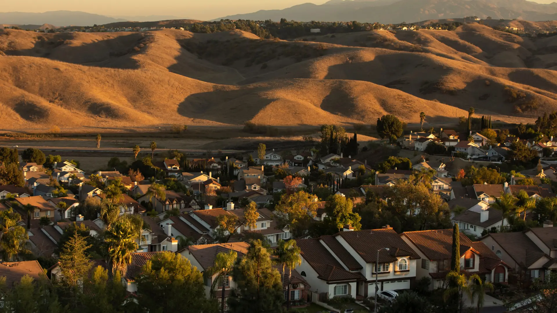 Driver assessing vehicle damage after a fender bender in Diamond Bar