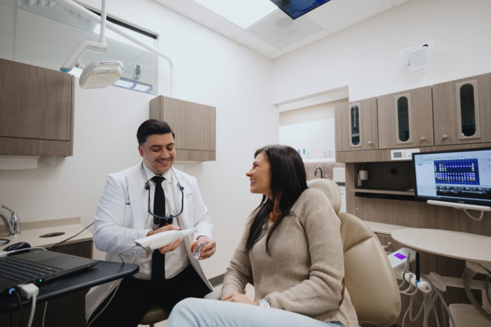 Dentist consulting with patient in modern dental office