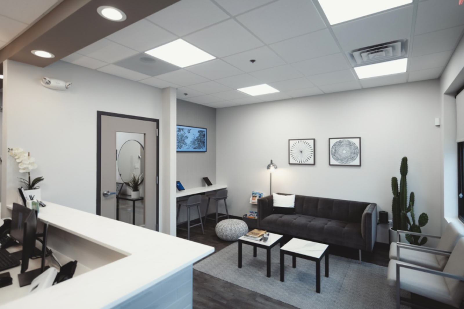 Modern dental office waiting room with comfortable seating and contemporary design