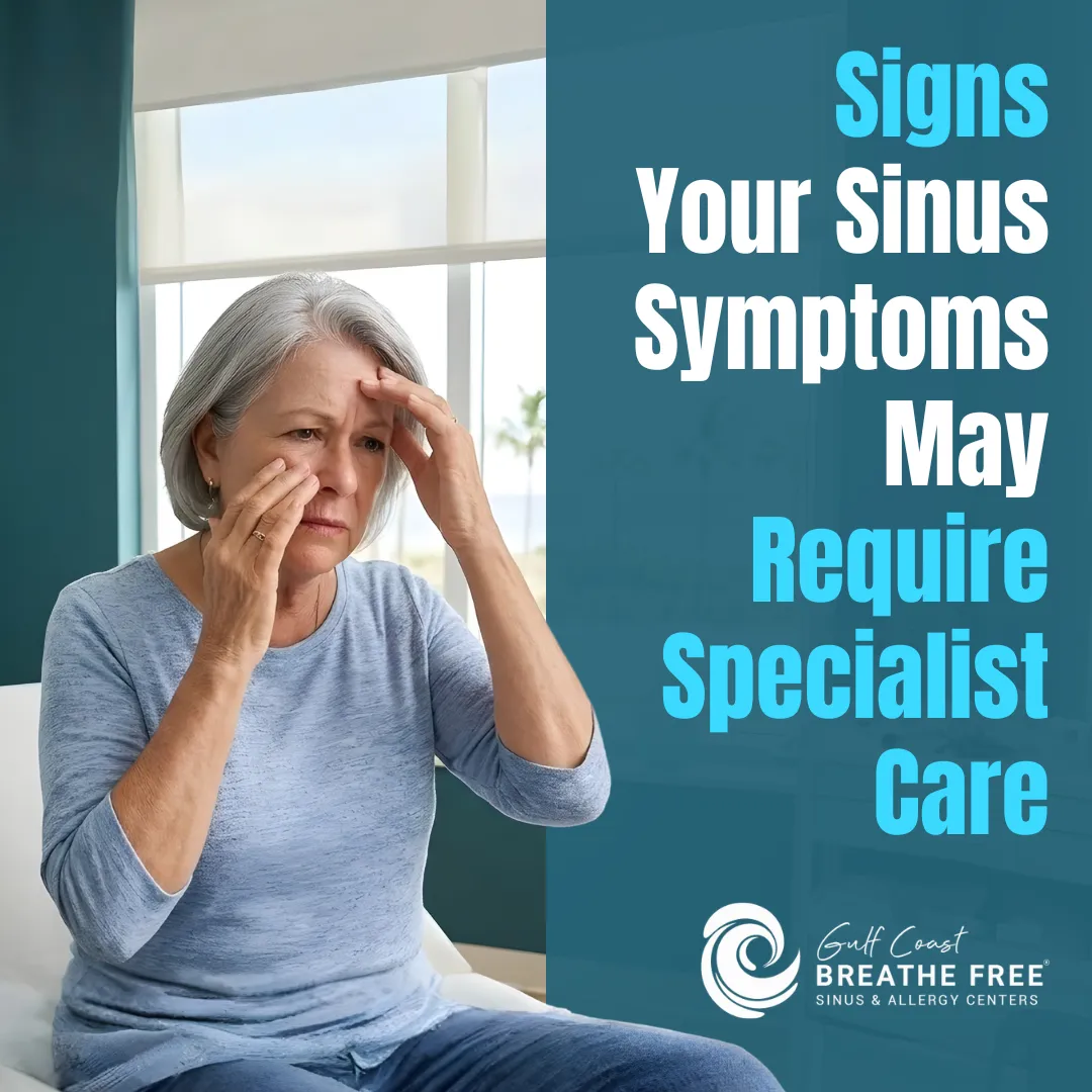 Woman pressing her fingers to her temples and the bridge of her nose, showing signs of sinus pressure or facial pain.