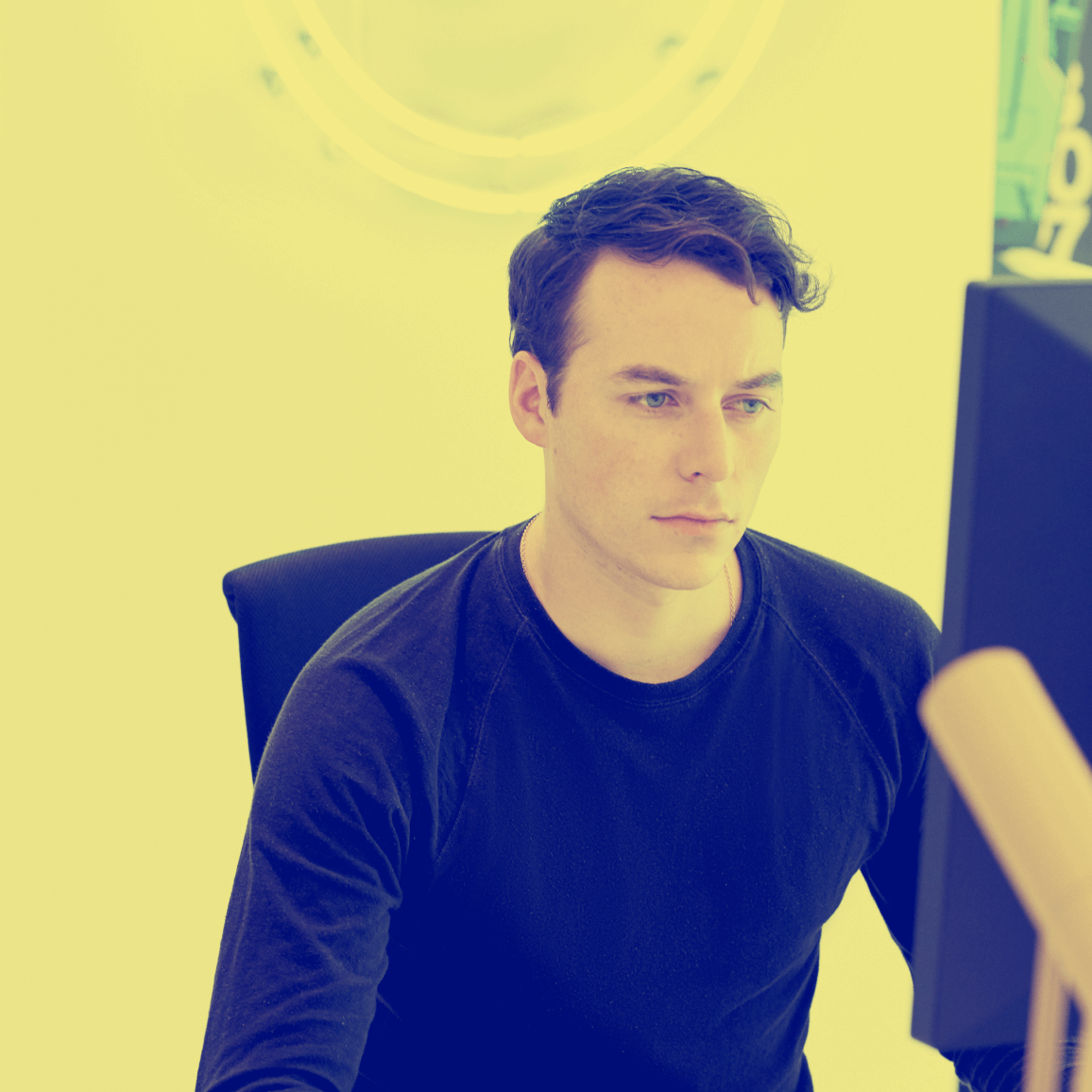 Photo of Tyler Galpin working at a desk.