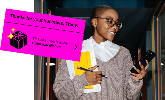 Cartoon hand pulling a curtain back from a gift campaign invitation email.