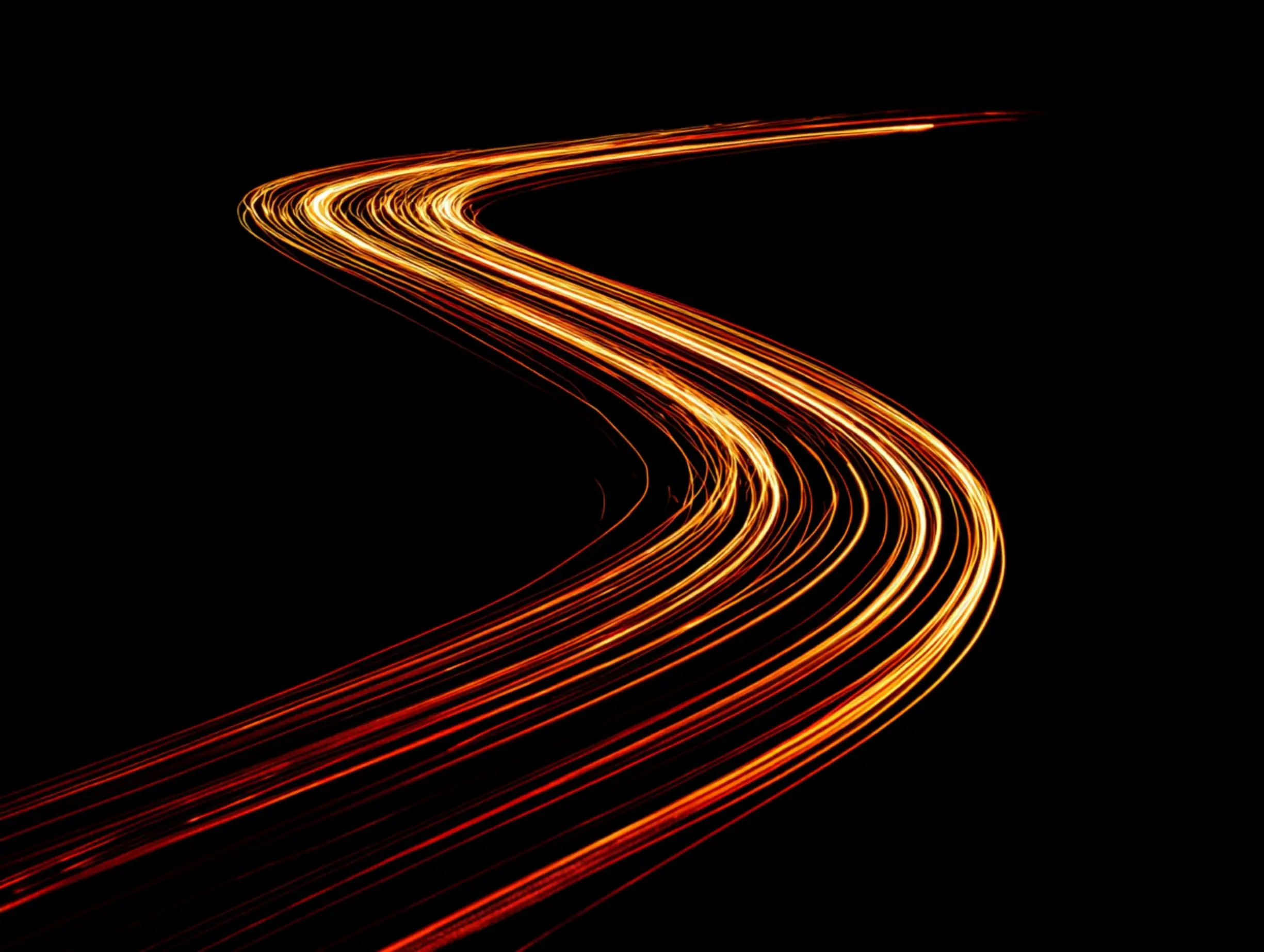 Speed Motion: helle Linien auf schwarzem Hintergrund lassen Straßenführung und fließenden Verkehr erkennen