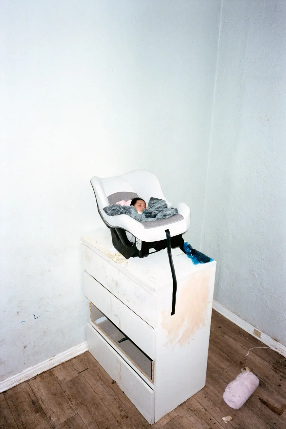 New Genesis by Abdulhamid Kircher — bathroom counter with crucifix, breast pump basket and feeding bottles photographed in a Los Angeles apartment.