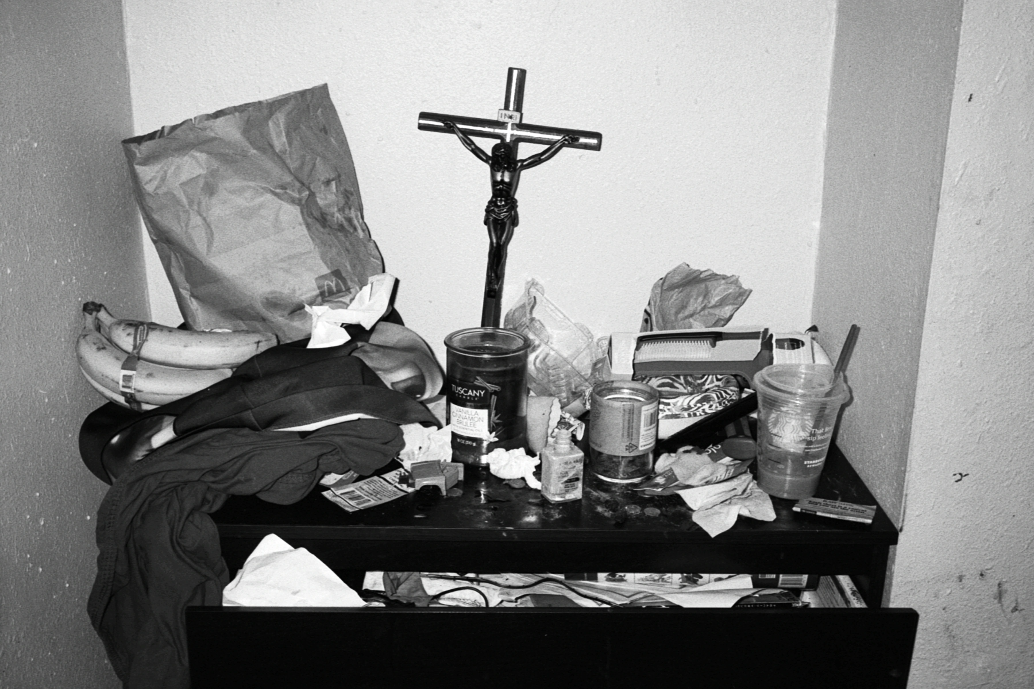 New Genesis by Abdulhamid Kircher — bathroom counter with crucifix, breast pump basket and feeding bottles photographed in a Los Angeles apartment.