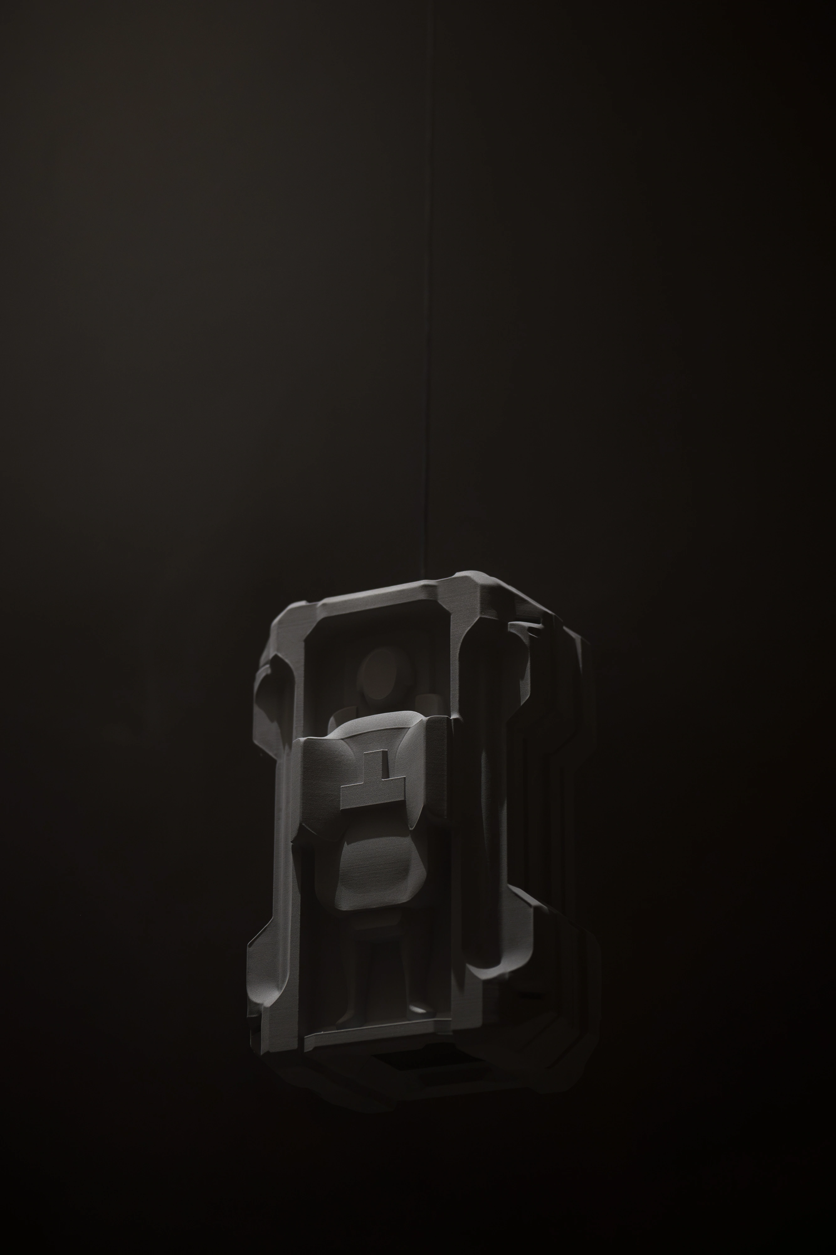 Strange Rules, Palazzo Diedo, grey modular object suspended in darkness, caged form with ambiguous anthropomorphic quality, installation detail