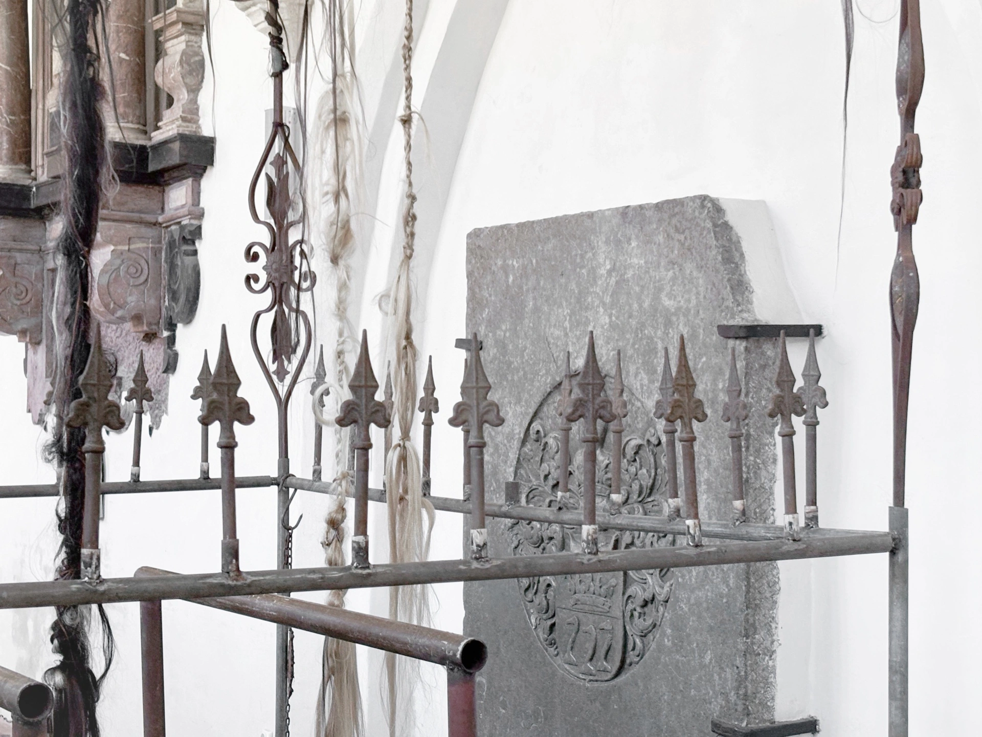 Angelika Puff, Bird Cage, 2025 — soil-filled base with accumulated human hair and metal rods emerging, close detail.