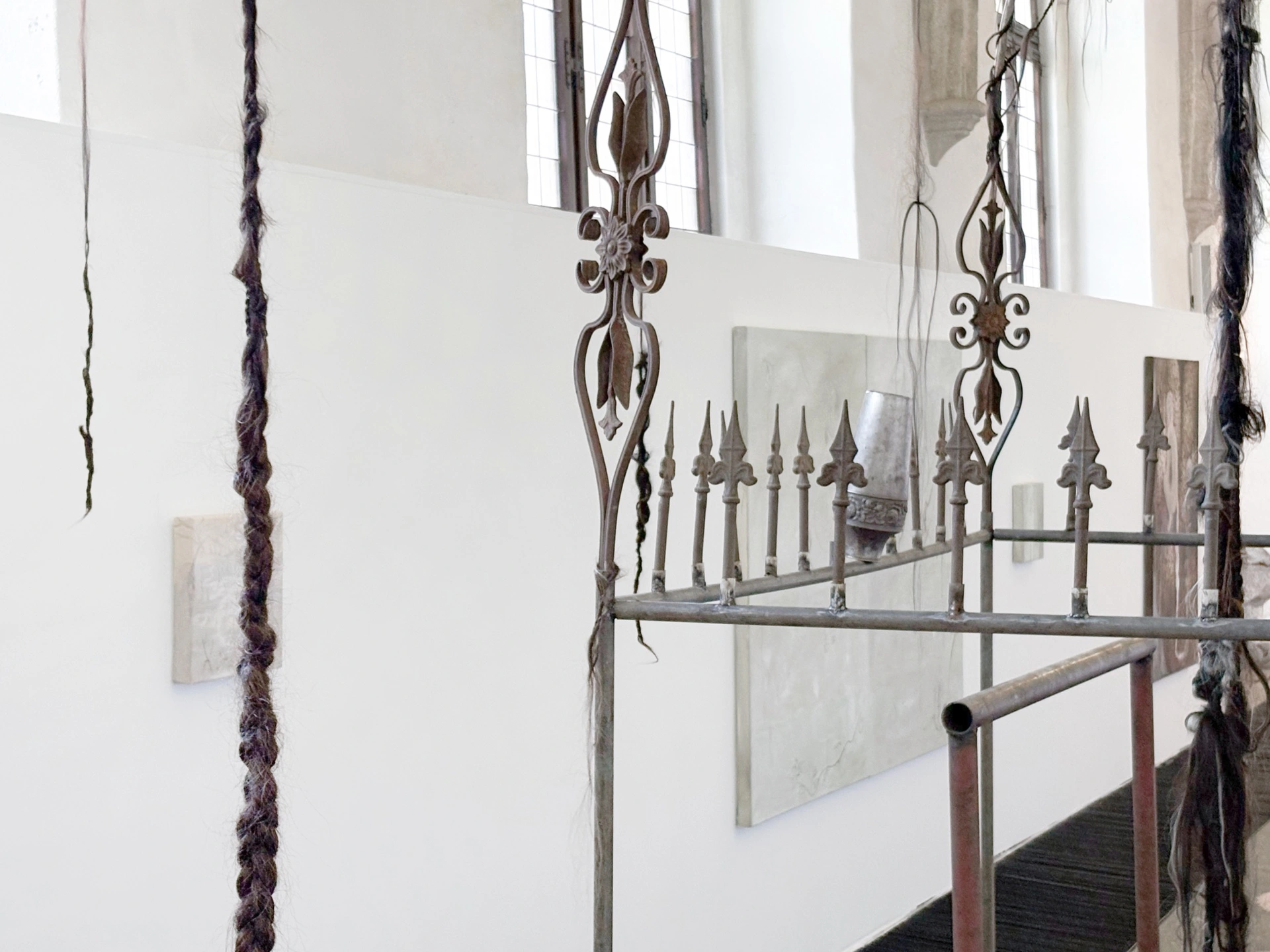 Angelika Puff, Bird Cage, 2025 — lateral view of the monumental 325cm cage with hair and soil inside the whitewashed church.