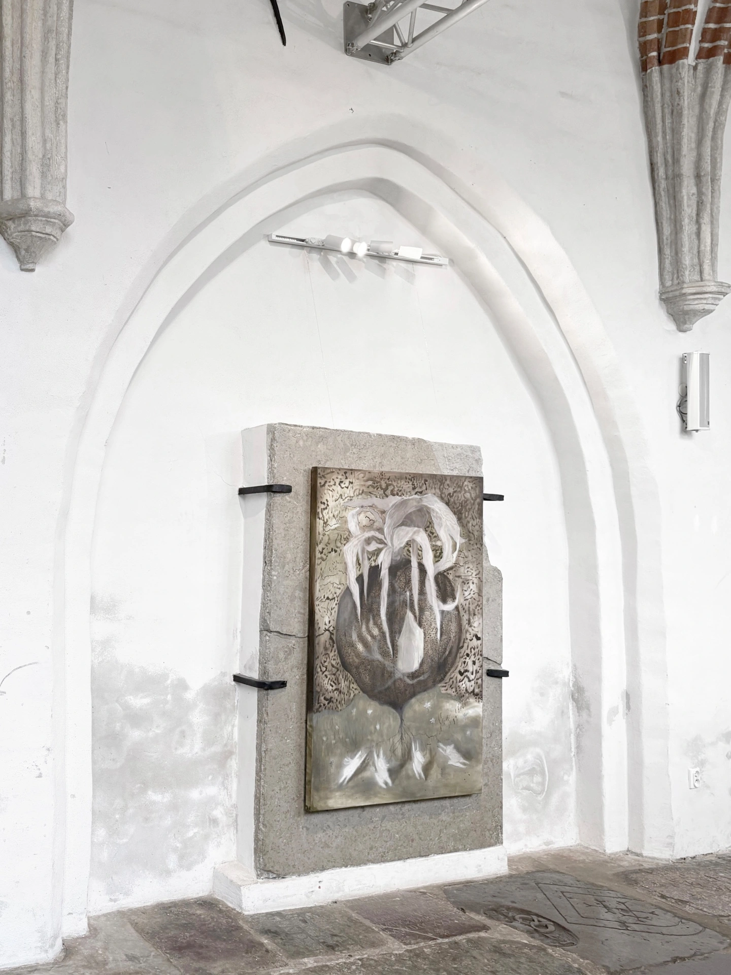 Angelika Puff, Sanctuary, a large ghostly canvas of a seed-like organic form installed on granite beneath a Gothic arch in the nave of Galeria EL.